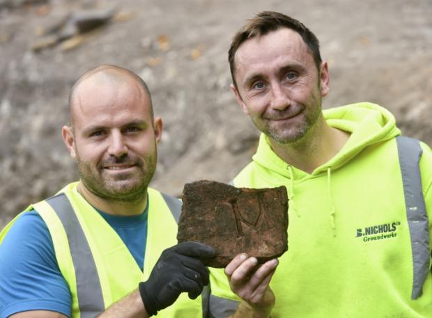 News and Star: Discovery: Volunteers found around 20 tiles stamped with the imperial emblem. Photo: Stuart Walker Photography.