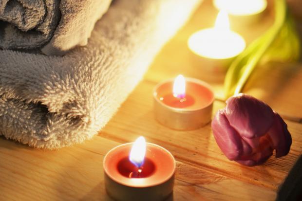 News and Star: A pile of towels, candles and a tulip. Credit: Canva