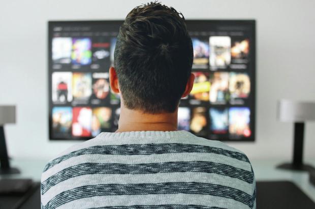 News and Star: A man watching a smart TV. Credit: Canva