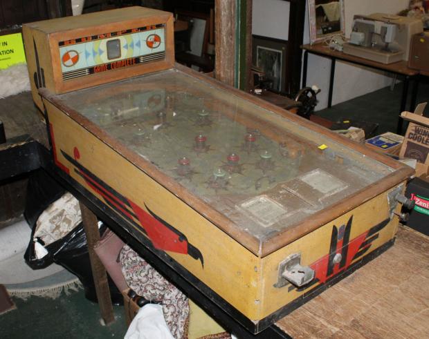 News and Star: A mid-century wooden pinball machine with a glass top and wooden legs makes £160