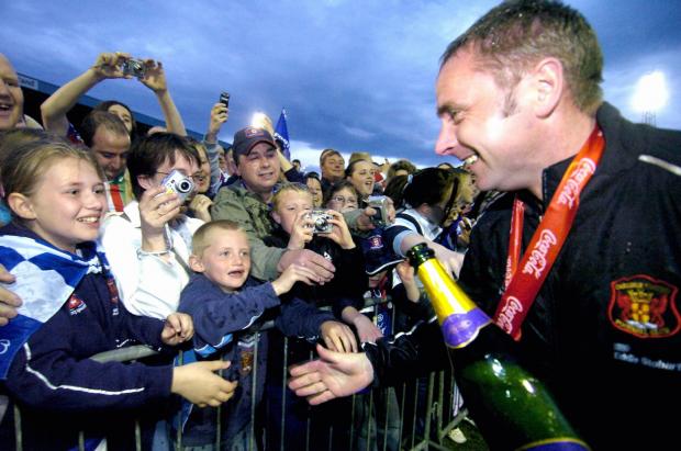 News and Star: Simpson greets fans after winning the League Two title in 2006