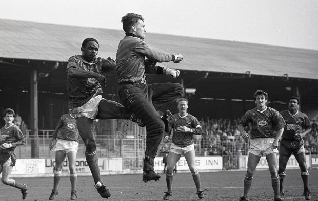 News and Star: Scarborough keeper Ironside punches clear under pressure from Walwyn as Nigel Saddington, centre looks on