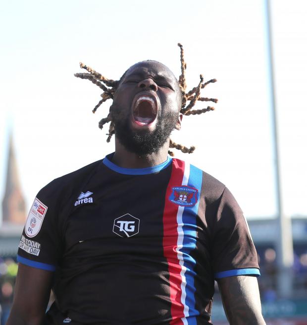 News and Star: Richard Parkes' iconic picture of Simeu celebrating after last weekend's victory at Barrow