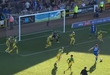 News and Star: Dennis, top right, takes up his position as Jordan Gibson shoots (screengrabs from Carlisle United YouTube)