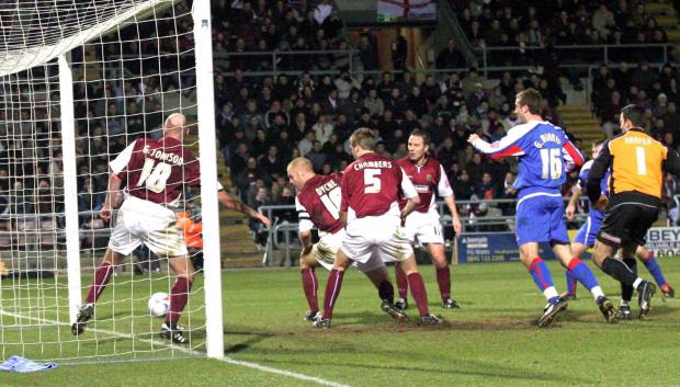 News and Star: Shaun Dyche, second left, can only watch as the shot from Danny Livesey, second right (partially obscured) makes it 3-0 to Carlisle