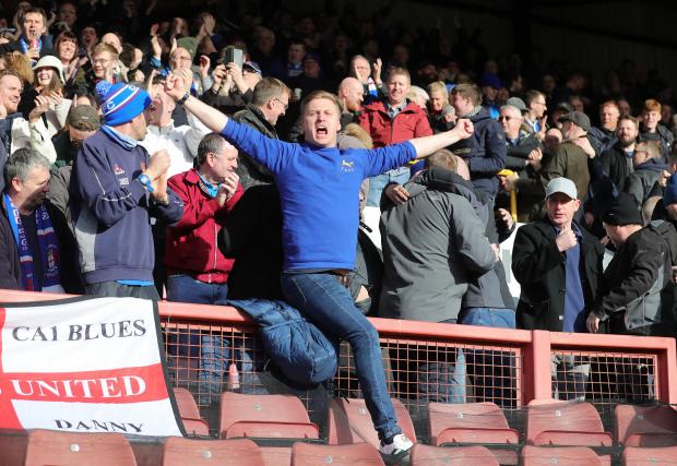 News and Star: United fan Martyn Haworth leads the celebrations at Orient (photo: Richard Parkes)