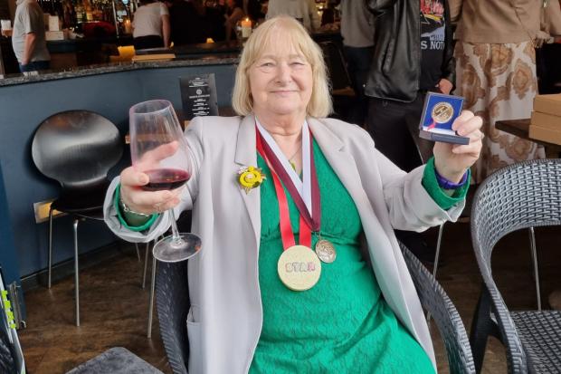 Picture, via Nanette Brimble, shows Christine Bousfield celebrating her medals.