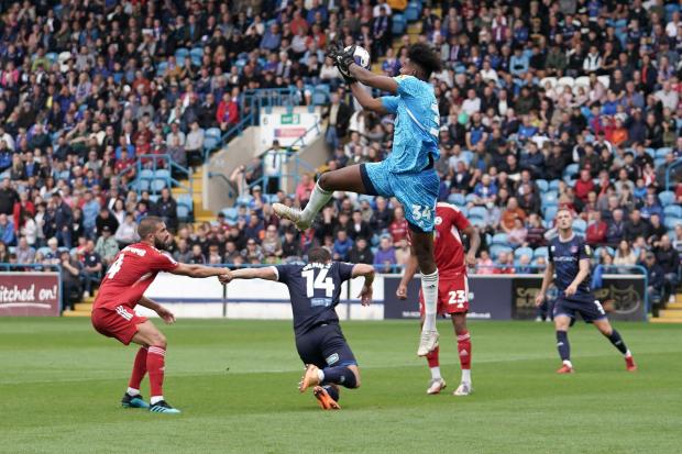 News and Star: Crawley's sub keeper Addai leaps for the ball