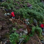 National Trust rangers from the Fix The Fells project repairing paths on Gowbarrow Fell, Cumbria. The staycation boom has led to an increase in the erosion of the Lake District landscape, according to an organisation set up to protect the area. Picture