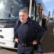 Paul Simpson pictured getting off the team coach for his first game back in charge of Carlisle at Leyton Orient in February 2022