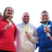 Nick Miller, centre, with his gold medal (photo:s: PA)
