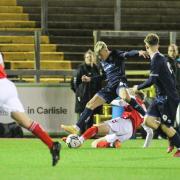 United's Ryan Carr tries to hurdle a Fleetwood challenge