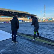 Referee Andrew Kitchen inspects a section of the pitch at Brunton Park on Friday morning