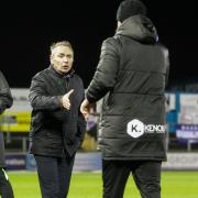 Paul Simpson shakes hands with Barrow's staff at United's 5-1 victory
