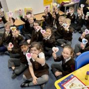 Children showing their hearts at Norman Street Primary School