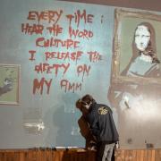 Fine Art Restoration conservationist works on famous gun-toting monkey Banksy mural