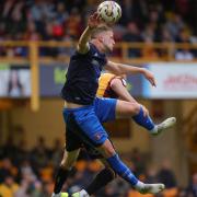 Jack Armer battles for an aerial ball at Bradford