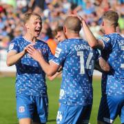 Fin Back, left, shows his delight after the second goal scored by Joe Garner, centre