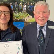 Laura Binnie, small animal vet and sustainability lead at Paragon, receiving the award from Chair of Cumbria in Bloom, Ronnie Auld