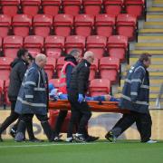 Callum Guy is stretchered off at Orient