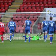 Tomas Holy goes the wrong way as Joe Pigott's penalty gives Orient the lead