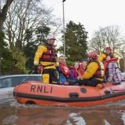 David and his family being taken from their home in the flood