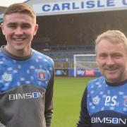 Harrison Neal, left, with Paul Simpson after signing for the Blues