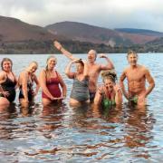 Cumbrian cold-water author Sara Barnes, third left, pictured in Derwent Water with fellow cold water swimmers