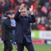 Paul Simpson applauds United's travelling fans after the defeat at The Valley