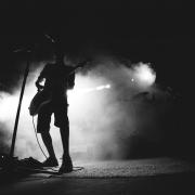 Stock image of a guitarist on stage. This is not a photo of the band, which eschews photos of themselves.