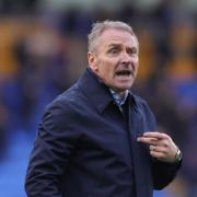 Paul Simpson pictured in an exchange with fans after full-time at Shrewsbury