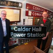 Martin Denvir (left), of Sellafield Ltd, hands over a piece of west Cumbrian railway to Perter Rooke