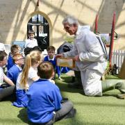 Harold Bowron, a beekeeper in Carlisle, showing pupils from Robert Ferguson primary school a real bee hive