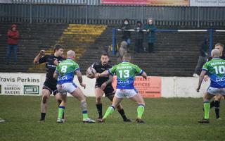 Greg Worthington looks for a gap among the Town players. Pictures: Leigh Ebdell