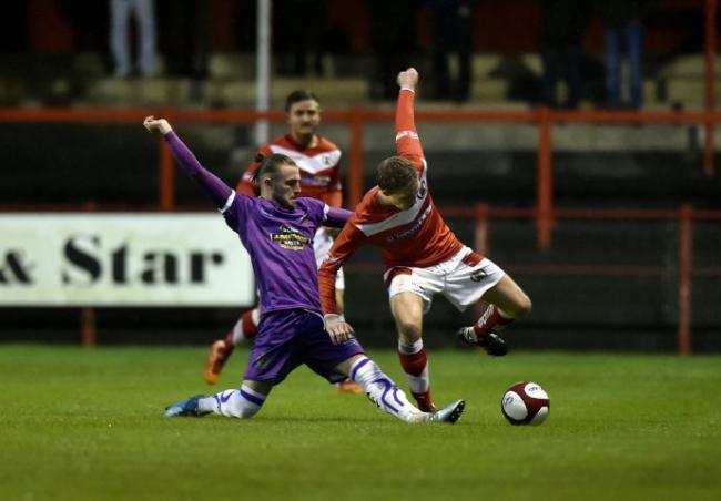 Reds' Conor Tinnion is challenged by Max Harrop
