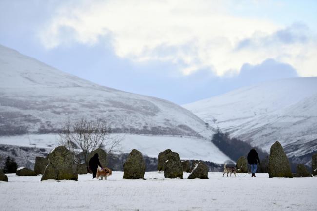 A light covering of snow across the high ground of Cumbria and the Lake District Fells. Visitors to Castlerigg Stone Circle near Keswick enjoy the winter scenes: 22 January 2019..STUART WALKER.